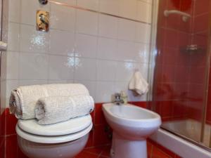 a bathroom with a toilet and a sink and a shower at Casa dolce casa - Metro in Sesto San Giovanni +8 photos
