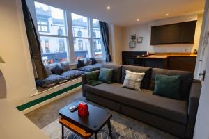 a living room with a couch and a large window at Cardiff City Centre - Luxury Apartments in Cardiff