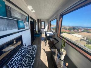a room with a fireplace in a house with windows at Pichilemu Apart Hotel in Pichilemu