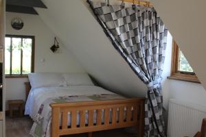 a bedroom with a bed in a attic at Oakwrights in Terling