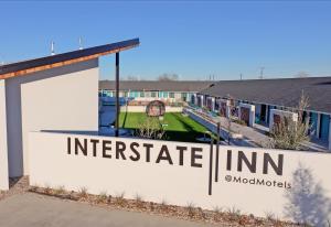 a sign for an interstate inn on the side of a building at Interstate Inn in Stephenville