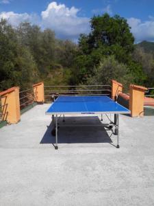 a blue ping pong table sitting in a parking lot at beautiful cottage with pool: 8 pers in Isolabona