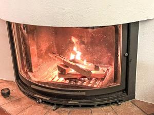 a fireplace with a fire in it at Holiday Home Midat soleil by Interhome in Verbier