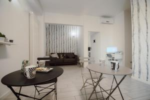 a living room with two tables and a couch at Civitavecchia HARBOUR VIEW in Civitavecchia