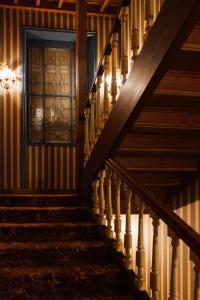 a staircase in a house with a stained glass window at Le Castel Marie Louise in La Baule