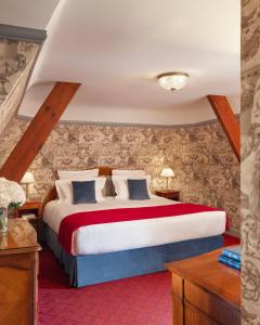 a bedroom with a large bed in a room at Le Castel Marie Louise in La Baule