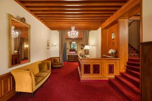 a living room with a staircase and a mirror at Le Castel Marie Louise in La Baule