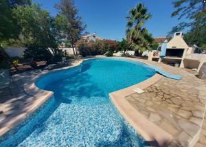 a swimming pool with blue water in a yard at La grangette in Marseillan