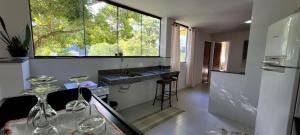 a kitchen with a sink and a counter with wine glasses at Espaço Brisa in Domingos Martins