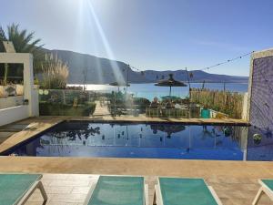 a swimming pool with a view of the water at Imsouane Magic House in Imsouane