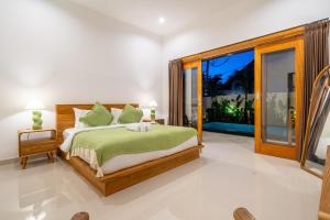 a bedroom with a bed and a large window at Lasterra - New Stylish Villa with Huge Pool - Steps from the Beach & Ultimate Luxury in Uluwatu
