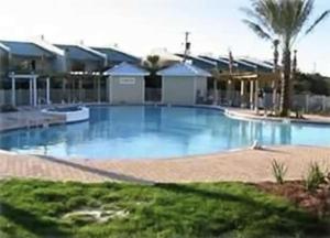 a large blue swimming pool in a resort at Bodacious Beach Retreat Condo in Destin in Destin