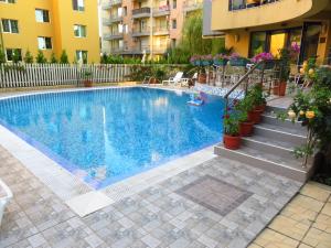 a swimming pool in a building with a person in the water at Aquaria Holiday Apartments in Sunny Beach +42 photos