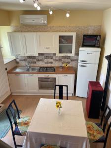 a kitchen with a table with a vase of flowers on it at B&B Da Felice in Serino