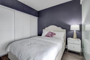 a bedroom with a white bed and a blue wall at CN lovers in Toronto +46 photos