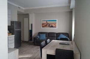 a living room with a table and a couch at BGY Central Apartments in Bergamo
