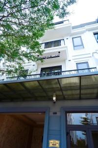 a white building with a balcony on top of it at Wabi Homes in Buon Ma Thuot