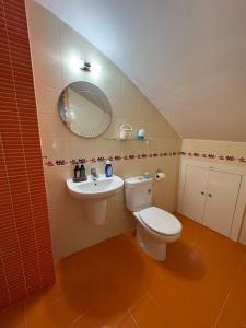 a bathroom with a toilet and a sink at Olivia in Barrio-Mar +14 photos