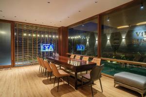 a dining room with a wooden table and chairs at Villa SuSu in Da Nang