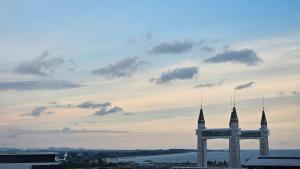 a large clock tower in a city with a cloudy sky at Siti Seaview Homestay, Pangsapuri Ladang Tanjung, Kuala Terengganu in Kuala Terengganu