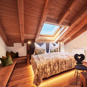 a bedroom with a large bed with a large window at activechalets six.nine.eight in Reit im Winkl +88 photos