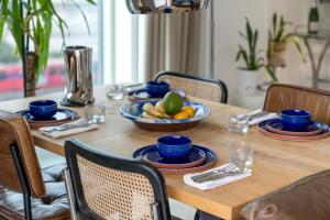 a wooden table with a bowl of fruit on it at Waterview apartments with ultra fast wifi close to Excel and O2, corporates and contractors welcome in London