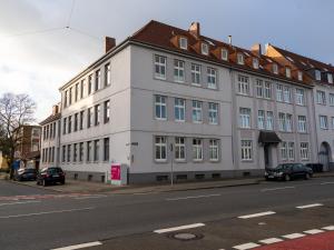 a large white building on the side of a street at 208 KüstenNest in Wilhelmshaven