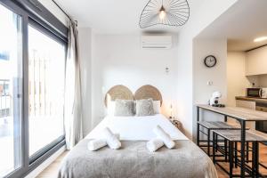 a bedroom with a large bed with white pillows at Elegant Studio with Private Terrace by RentitUP in San Sebastián de los Reyes