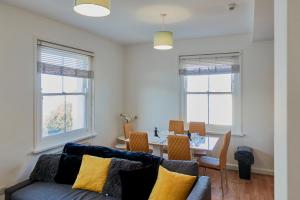 a living room with a couch and a table at River Front Apartment in Kent
