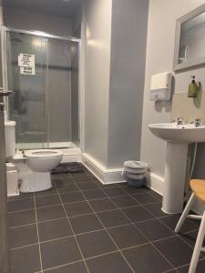 a bathroom with a shower and a toilet and a sink at The Prince Alfred Rooms in Liverpool
