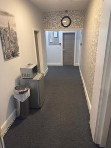 a hallway with a toilet and a clock on the wall at The Prince Alfred Rooms in Liverpool