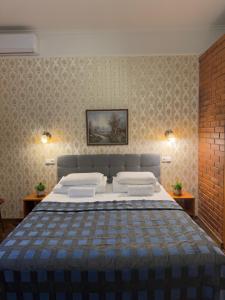 a bedroom with a large bed in a room with wallpaper at Green Villa in Pärnu