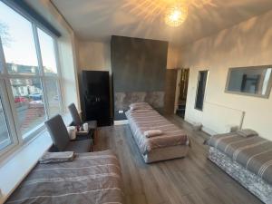 a large living room with couches and a large window at The Prince Alfred Rooms in Liverpool