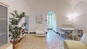 a living room with a table and a dining room at Casa del Teatro in Borgio Verezzi