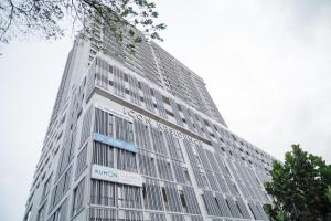 a tall white building with a sign on it at Melati Homestay in Kuala Terengganu