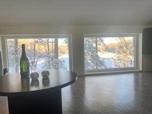 a room with a table and a bottle of wine at B2 Lakeside Suite Polku Hotel in Vihti