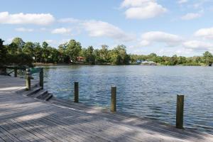 a dock with a view of a body of water at Front Lake View 4Bed Home with Pool and Mins to Mall in Doolandella