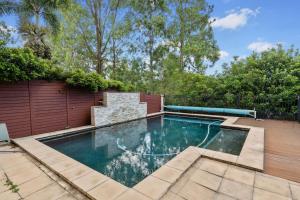 a swimming pool in the backyard of a house at Front Lake View 4Bed Home with Pool and Mins to Mall in Doolandella