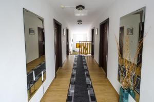 a hallway with black and white tile on the floor at Penzion Globus in Český Krumlov