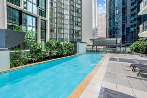 an outdoor swimming pool in a building with tall buildings at Best Value 2Beds Apt at CBD with Pool Gym Carpark in Brisbane