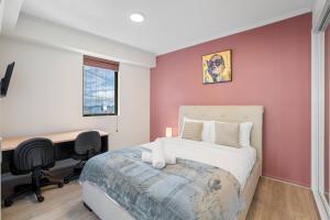 a bedroom with a bed and a desk with a computer at Best Value 2Beds Apt at CBD with Pool Gym Carpark in Brisbane +10 photos