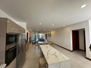 a kitchen and living room with a counter top at Joyau de pointe aux Canonniers in Grand Baie