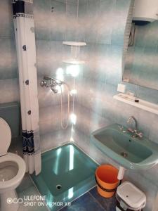 a bathroom with a tub and a toilet and a sink at Room in Lopar with Balcony, WIFI 4620-95 in Lopar