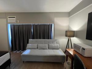 a living room with a bed and a window at Hotel Live Lodge Ibirapuera UH519 in Sao Paulo
