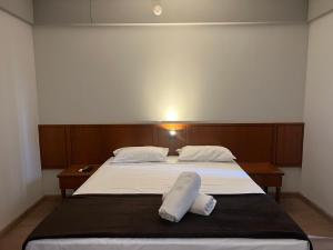 a bedroom with a bed with two pillows on it at Hotel Live Lodge Ibirapuera UH519 in Sao Paulo +22 photos