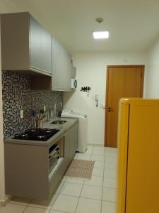 a kitchen with a stove and a sink in it at Lugar encantado - Apartamento in Brasília +9 photos