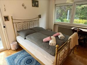 a bedroom with a bed with two pillows on it at GartenOase in der Universitätsstadt 3 Zimmer Haus mit Parkplatz in Erlangen +5 photos