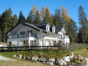 a large white house with a black roof at Haus Terra in Ramsau am Dachstein