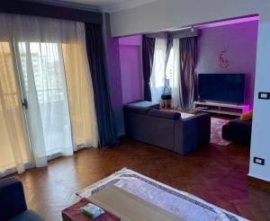 a living room with a couch and a tv at Luxury Apartment Cairo Egypt in Cairo