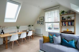 a living room with a couch and a table at Historic Wing in Tring: Cozy and Scenic in Tring